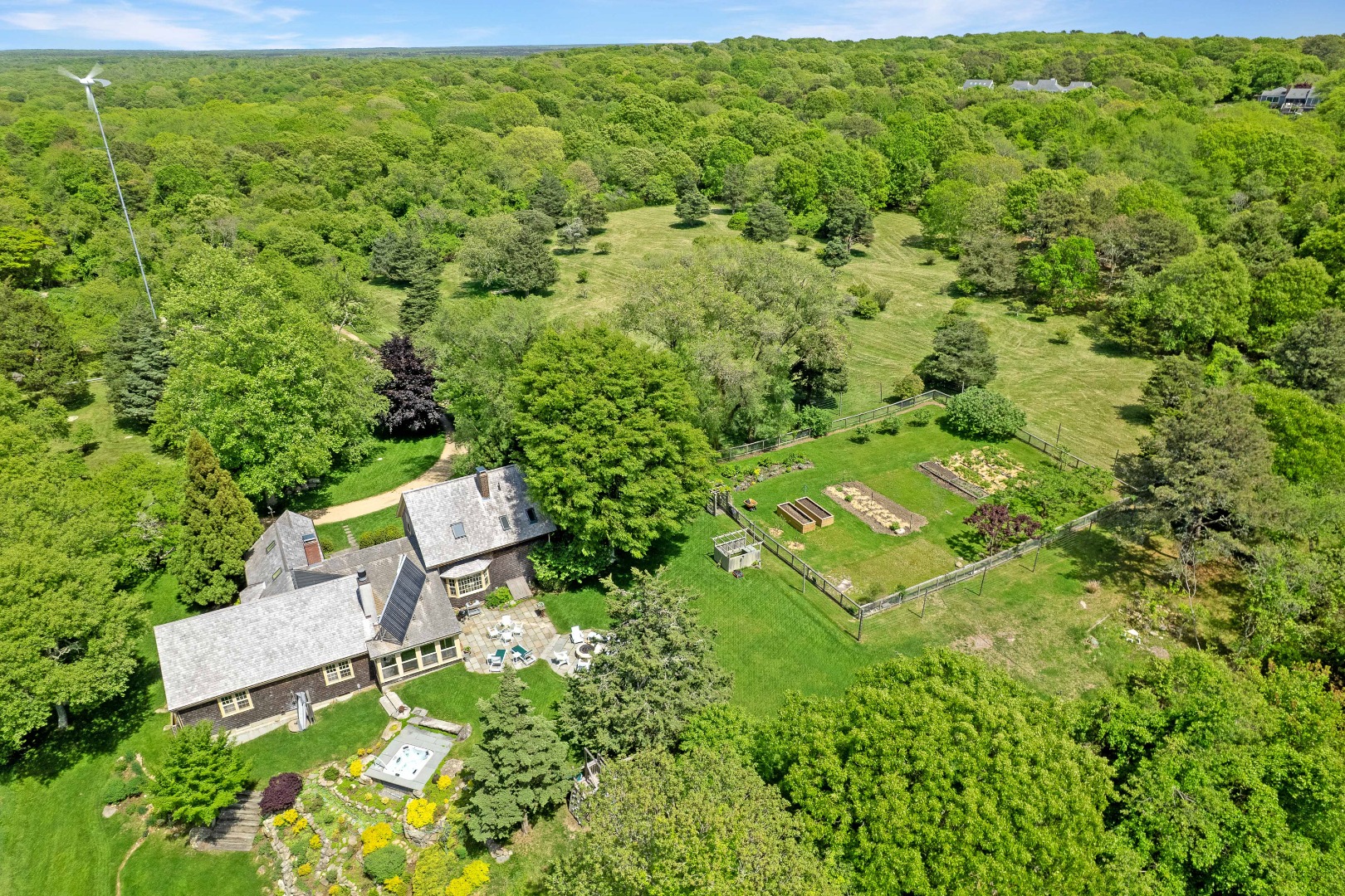 122 Old Farm Road Chilmark, MA 02535 - Photo 5 of 36 a view of a yard with table and chairs and plants