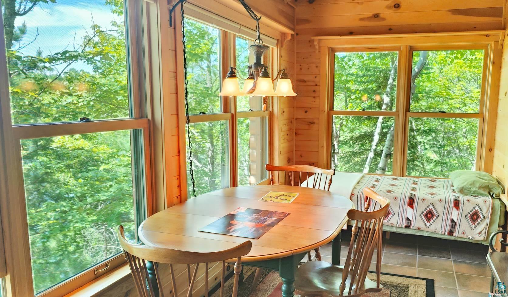 2357 Retreat Lodge Road Cook, MN 55723 - Photo 16 of 45 Dining space featuring wood walls and tile patterned flooring