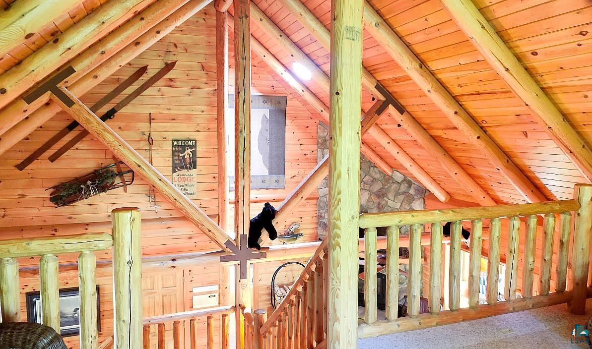 2357 Retreat Lodge Road Cook, MN 55723 - Photo 31 of 45 Corridor with wooden ceiling, wooden walls, carpet floors, and an upstairs landing