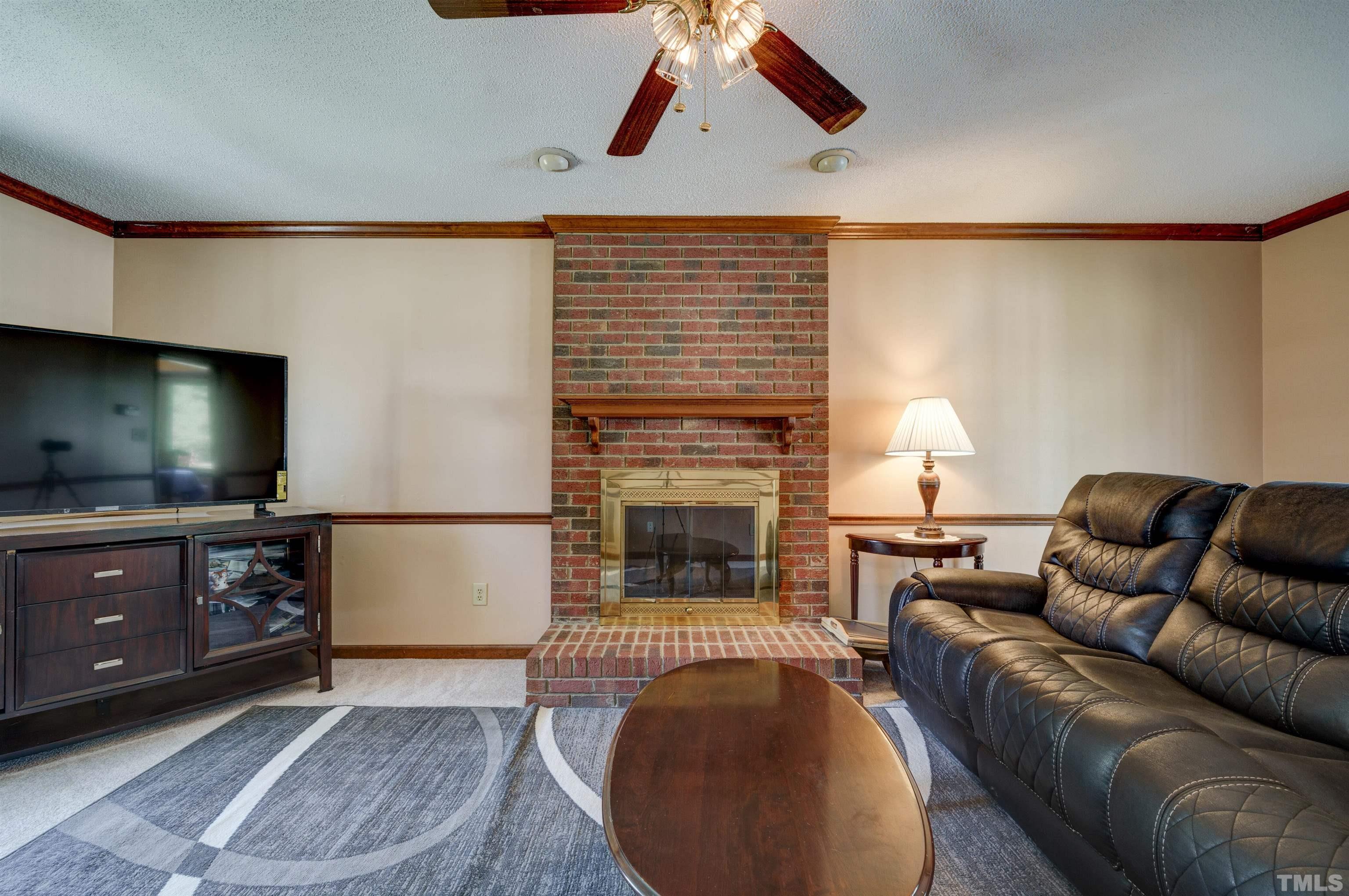 429 South Meadow Road Raleigh, NC 27603 - Photo 14 of 44 a living room with furniture and a fireplace