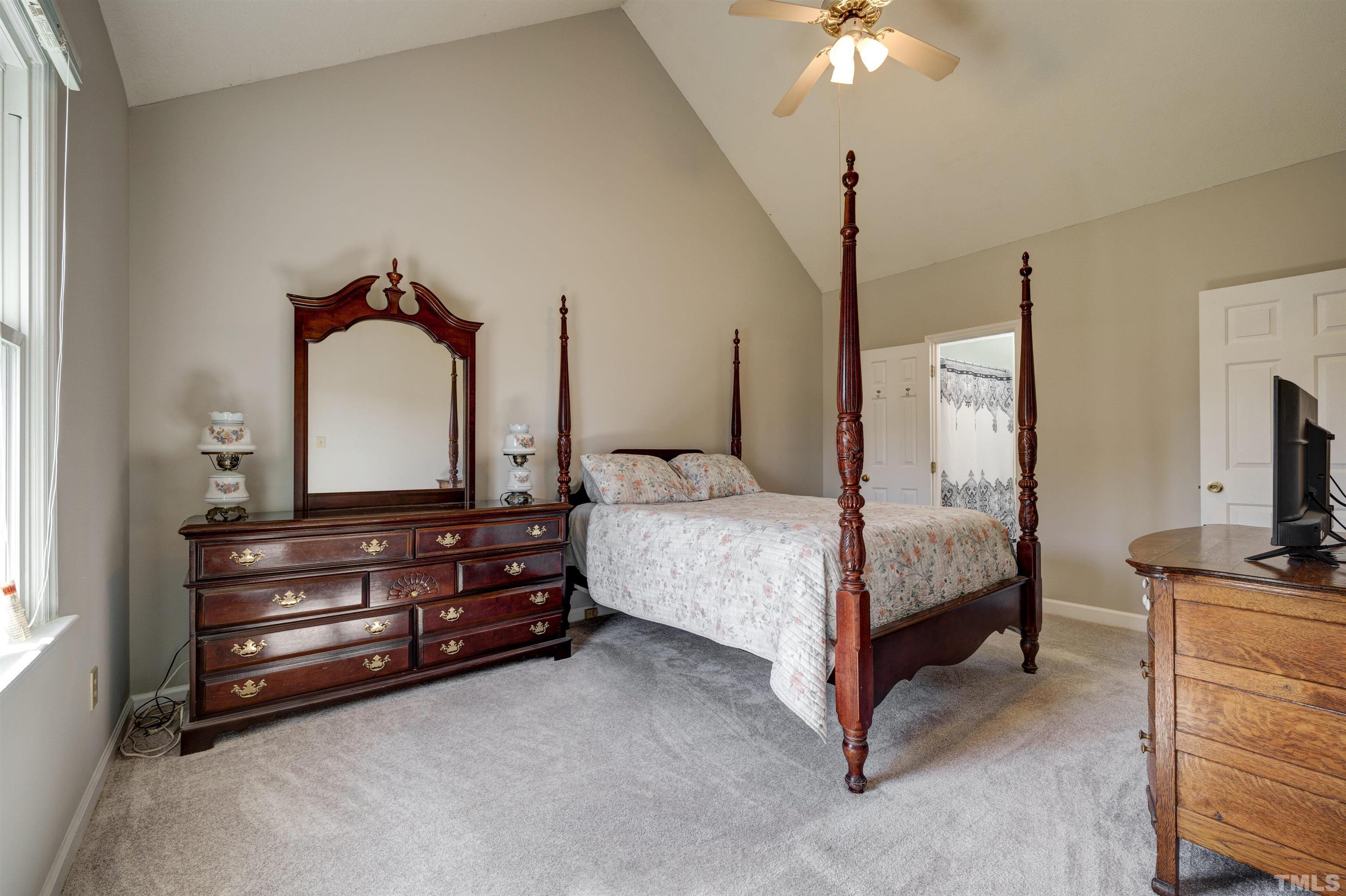 429 South Meadow Road Raleigh, NC 27603 - Photo 19 of 44 a bedroom with a bed and a chandelier
