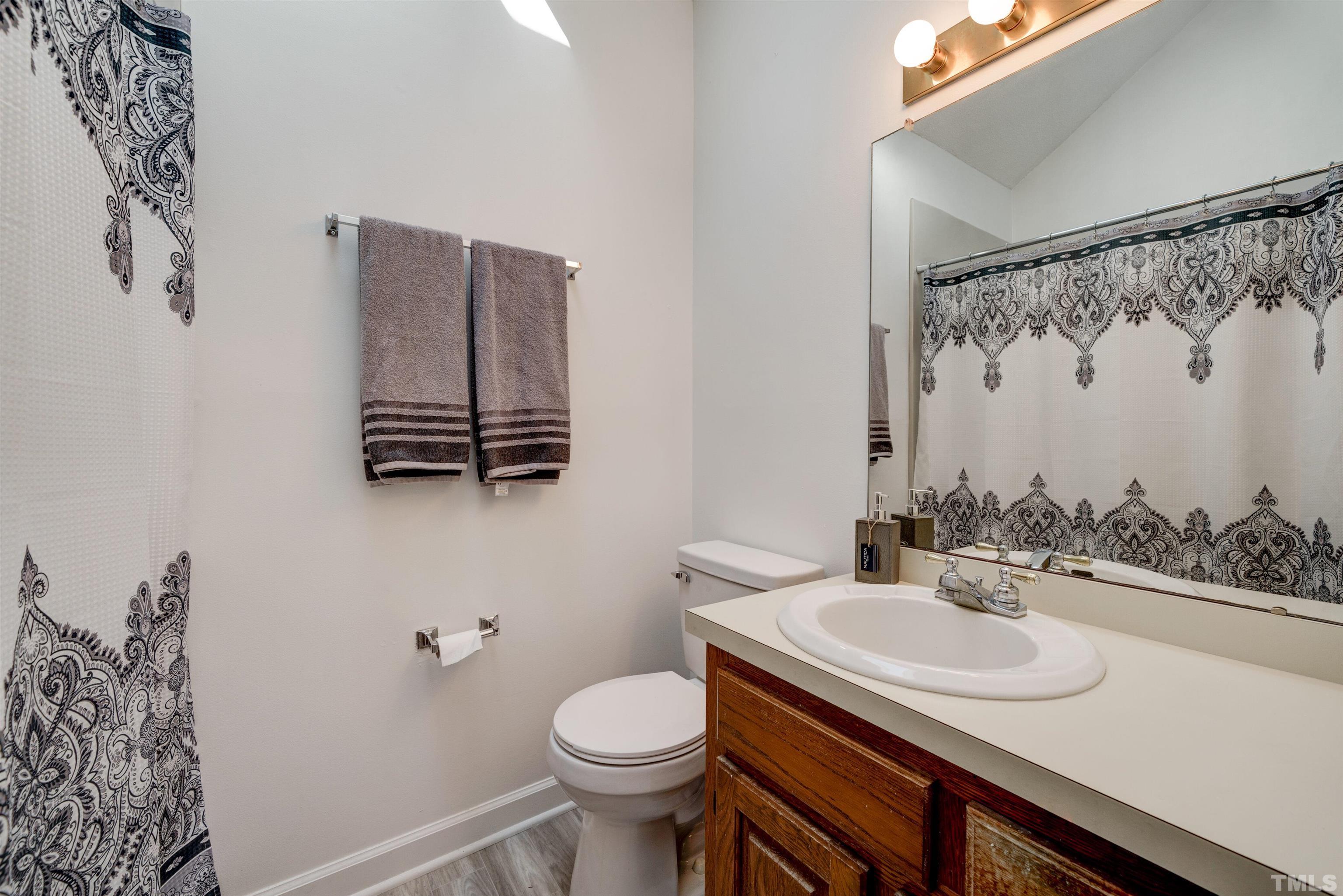 429 South Meadow Road Raleigh, NC 27603 - Photo 22 of 44 a bathroom with a sink toilet and shower