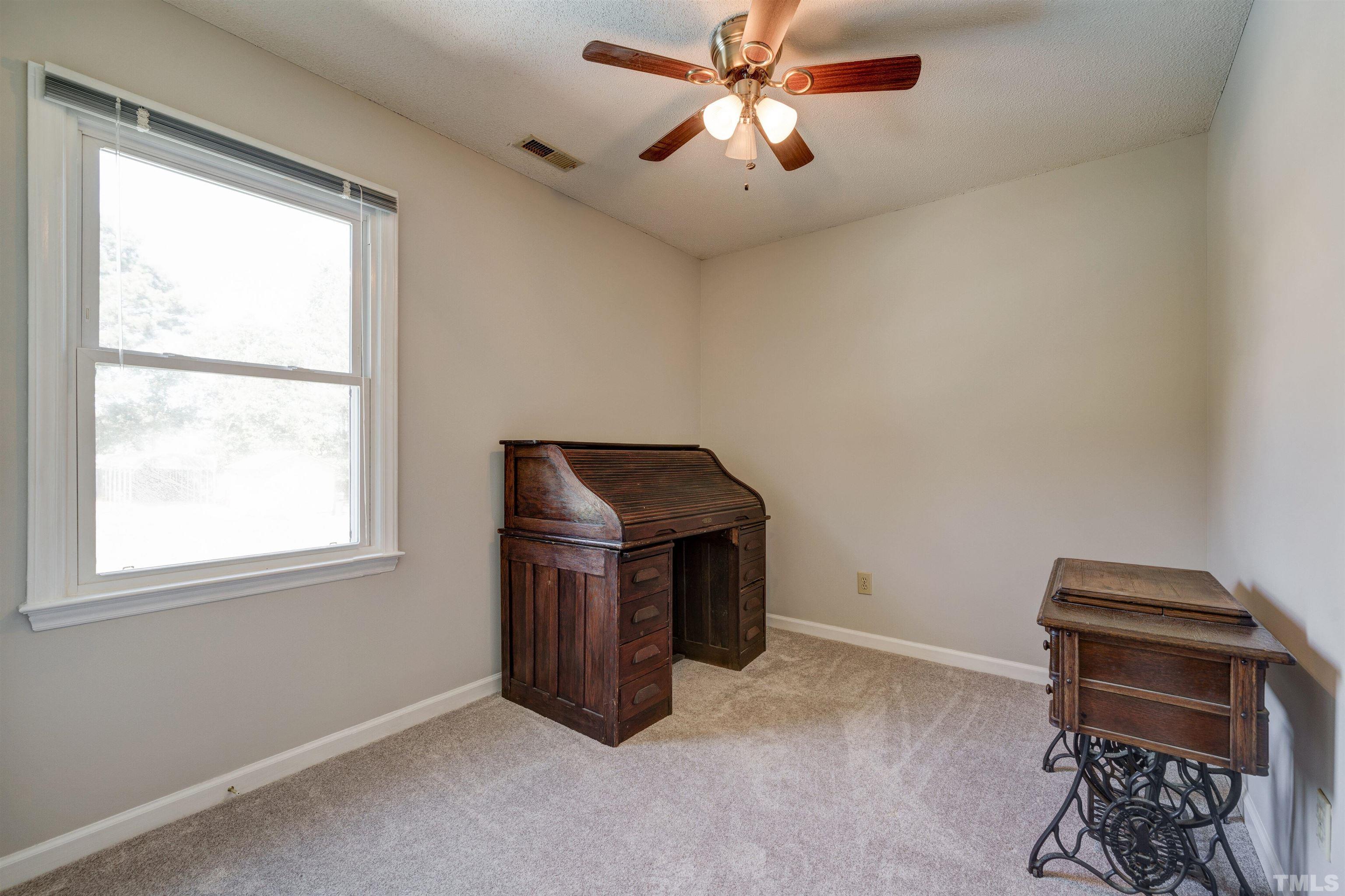 429 South Meadow Road Raleigh, NC 27603 - Photo 23 of 44 an empty room with windows and ceiling fan