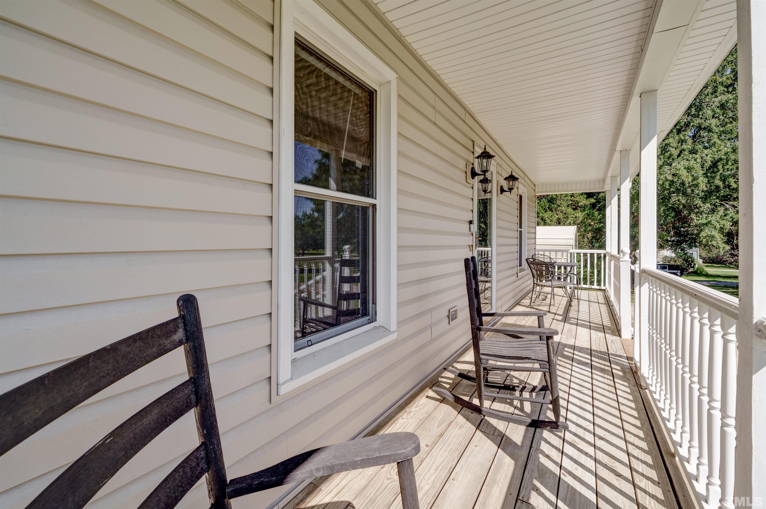 429 South Meadow Road Raleigh, NC 27603 - Photo 32 of 44 a view of a porch with furniture and floor to ceiling window