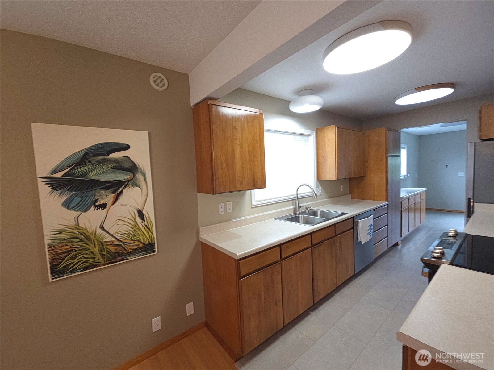 240 Stringtown Road Ilwaco, WA 98624 - Photo 8 of 39 a large kitchen with a sink a stove and wooden floor