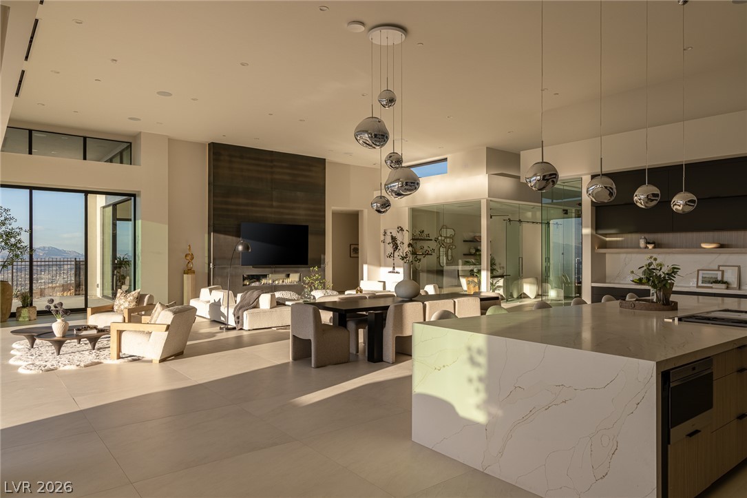 563 Grand Rim Drive Henderson, NV 89012 - Photo 14 of 70 An open-concept living space with sleek modern finishes offers abundant natural light and sweeping panoramic views.