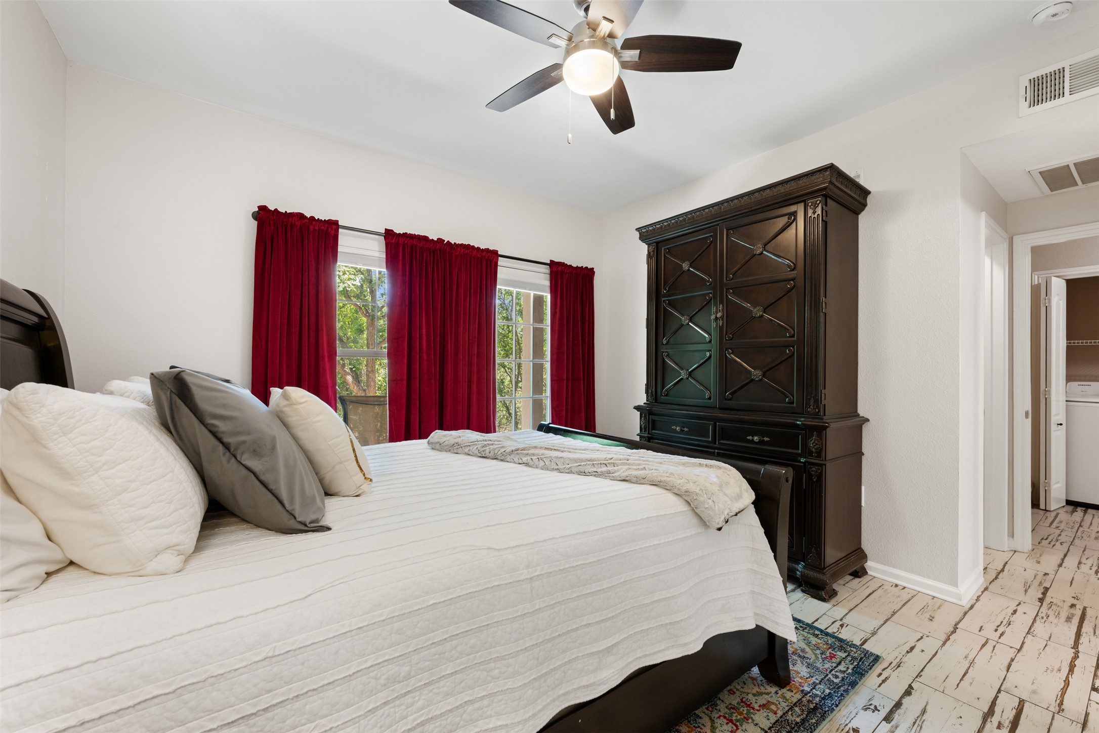 11203 Ranch Road 2222, Unit 1407 Austin, TX 78732 - Photo 10 of 40 The primary suite offers ample room for a king sized bed and comes with beautiful wood-look tile flooring.