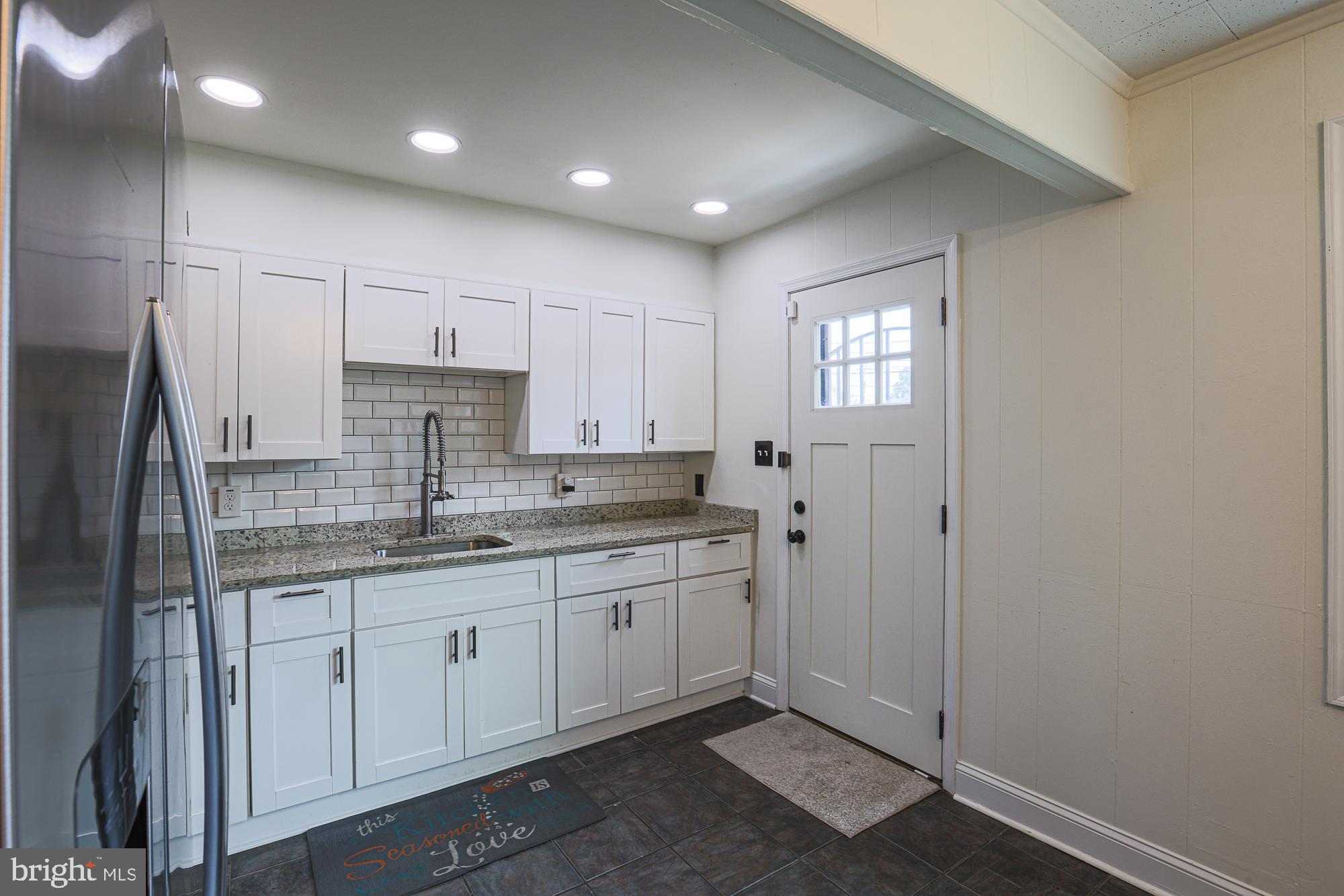 191 Alstun Road Essex, MD 21221 - Photo 23 of 40 a kitchen with kitchen island granite countertop cabinets and stainless steel appliances