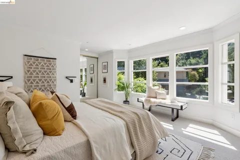 a living room with furniture a mirror and a table