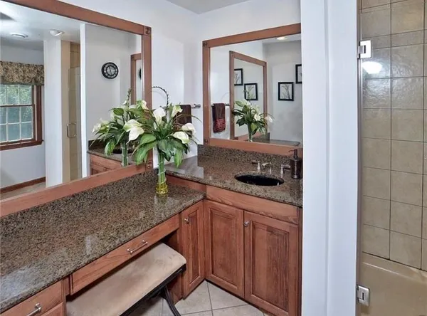 a kitchen with sink and potted plant