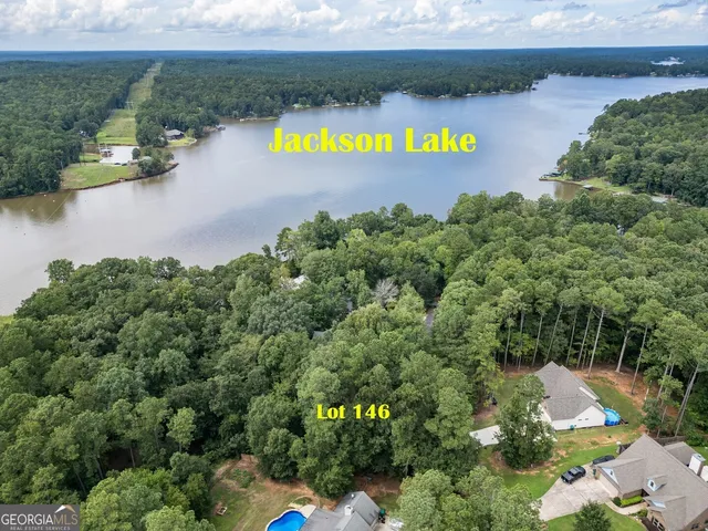 an aerial view of a house with a yard and lake view