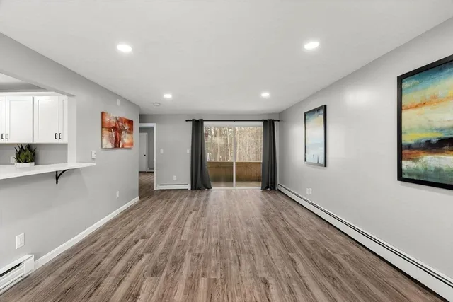 a view of a kitchen with a refrigerator and a window