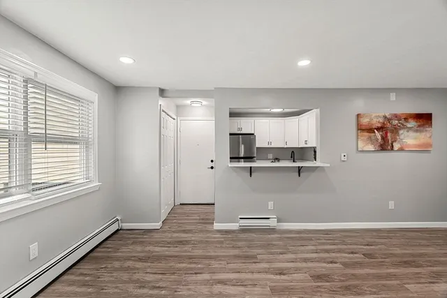 a view of empty room with wooden floor