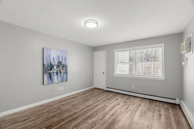 a view of a livingroom with wooden floor and window