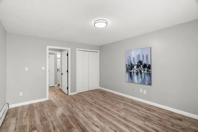 a view of an empty room with wooden floor
