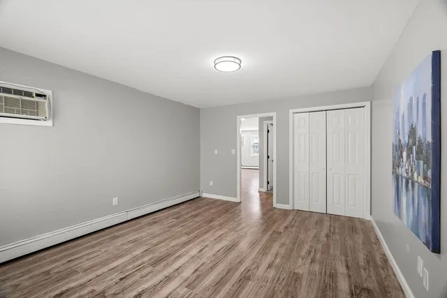 an empty room with closet and wooden floor