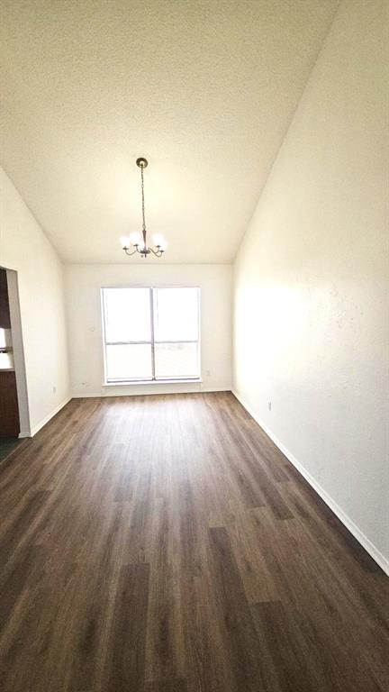 5224 Timber Creek Road Flower Mound, TX 75028 - Photo 4 of 10 an empty room with wooden floor cabinet and windows