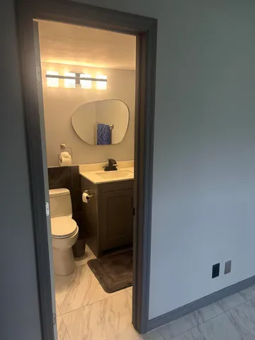 a bathroom with a shower and a mirror