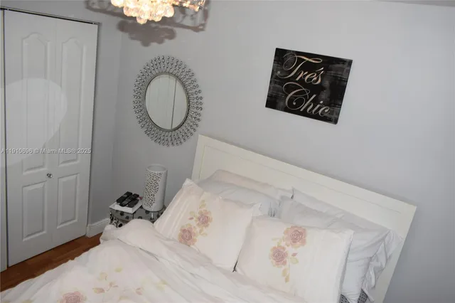 a bedroom with a bed and a mirror