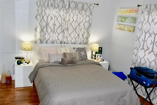 a bed sitting in a bedroom next to a lamp