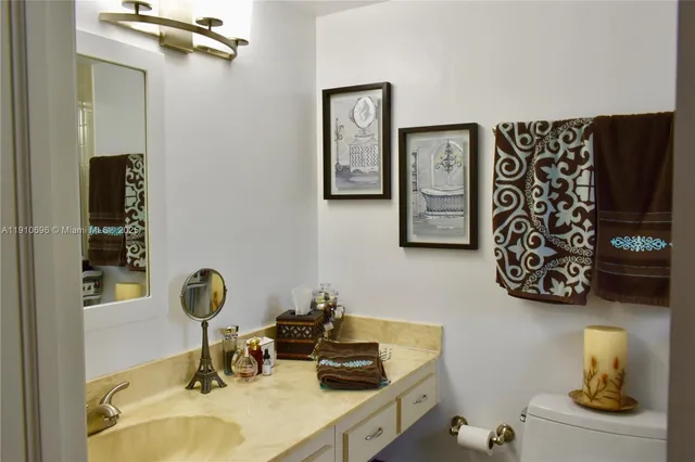 a bathroom with a sink mirror and vanity