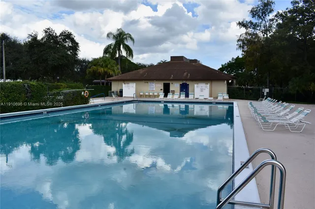 a view of a house with pool yard and outdoor seating