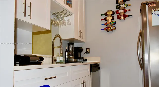 a kitchen with a refrigerator and a sink