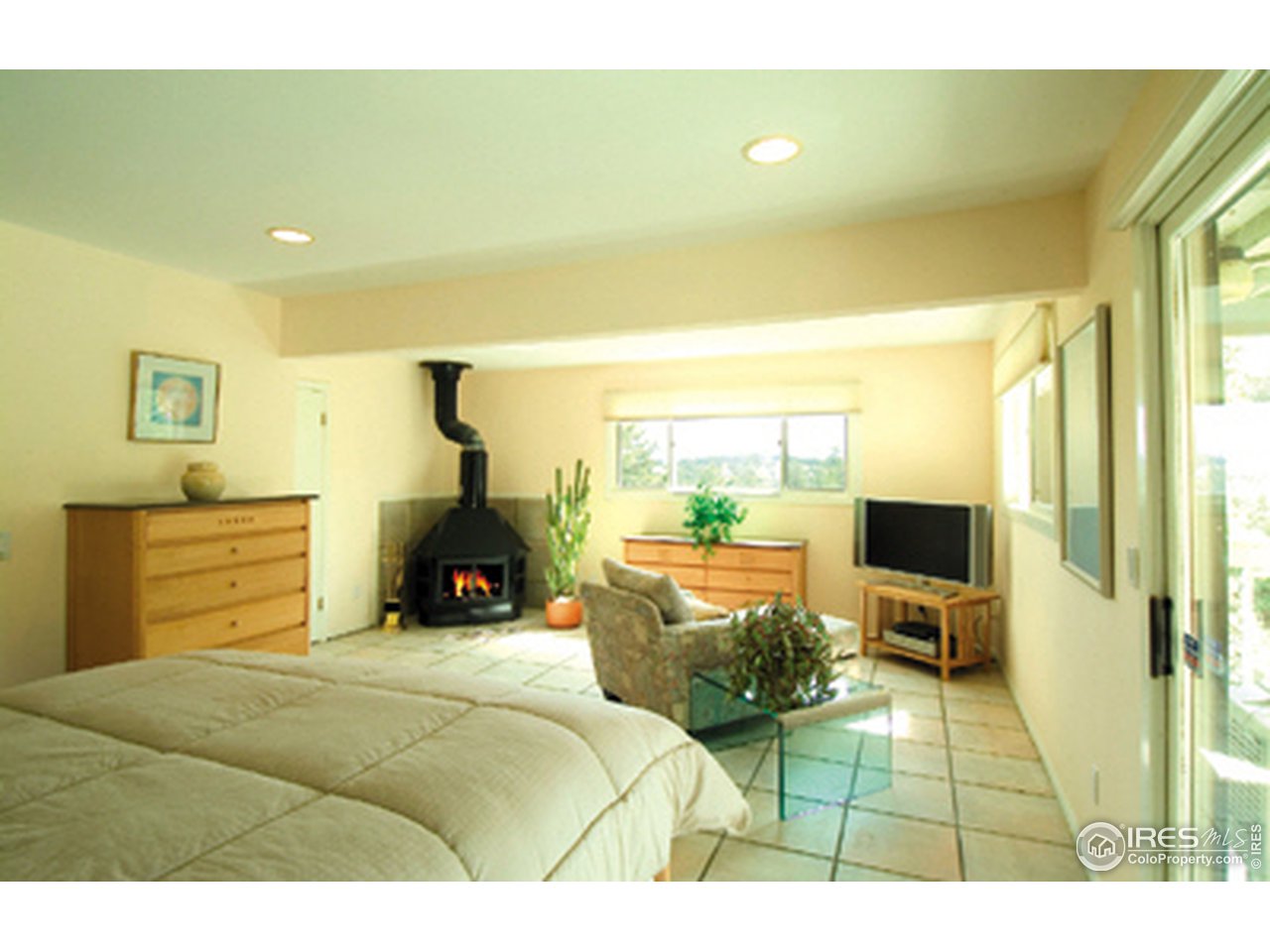 975 Kelly Road West Boulder, CO 80302 - Photo 7 of 8 a bedroom with a bed and wooden floor
