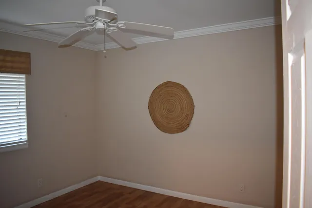 an empty room with a chandelier fan