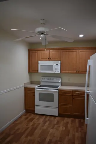 a kitchen with granite countertop a sink and a stove top oven