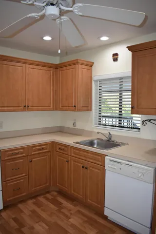 a kitchen with a sink cabinets and window