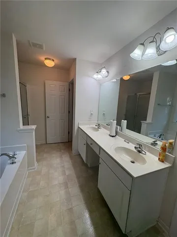 a bathroom with a double vanity sink mirror and double