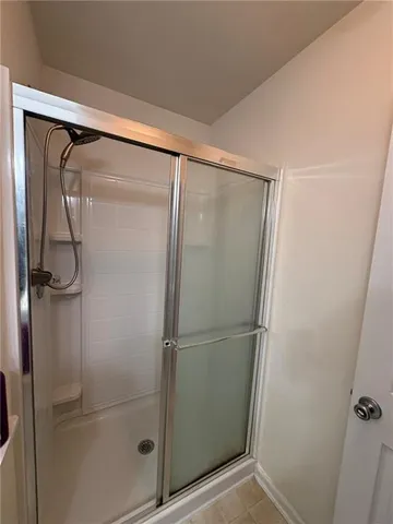 a bathroom with a glass shower door