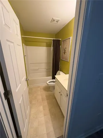 an empty room with a white cabinet and cabinet