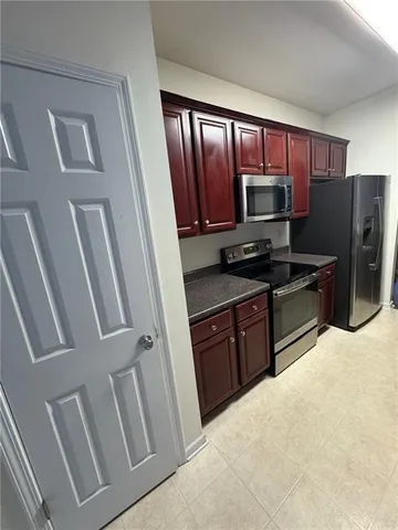 a kitchen with stainless steel appliances granite countertop a refrigerator stove microwave and sink