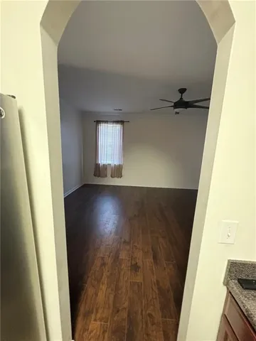a view of a room with wooden floor and staircase