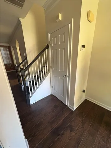 a view of a hallway with wooden floor