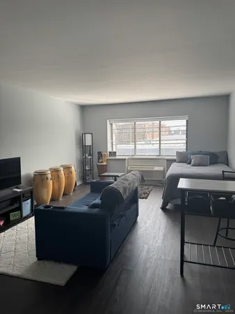 a bedroom with furniture and a window