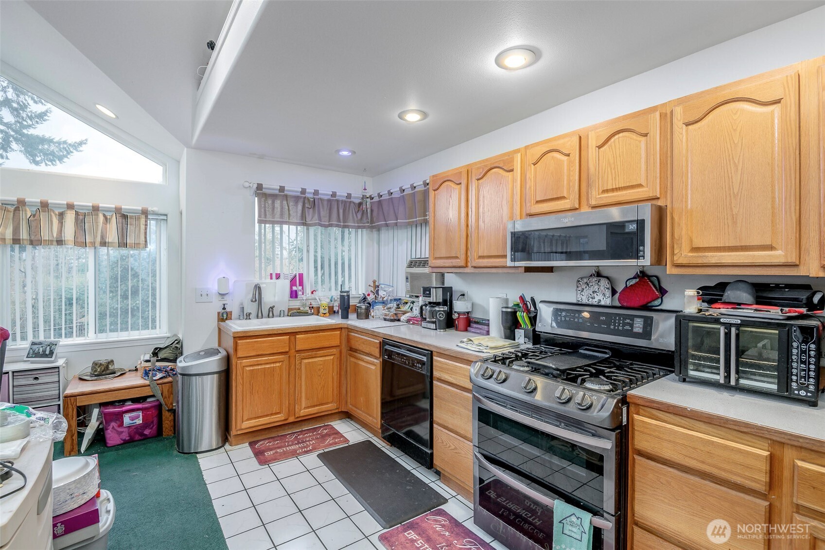 4048 Southeast Horstman Road Port Orchard, WA 98366 - Photo 20 of 40 a kitchen with kitchen island granite countertop a sink a counter top space appliances and cabinets