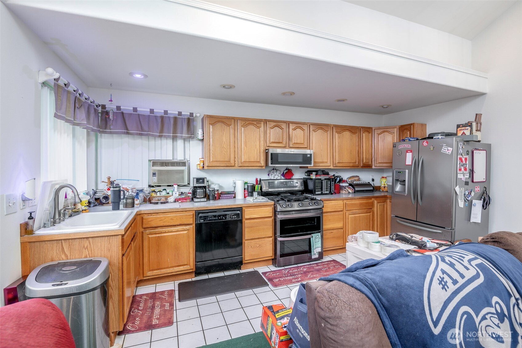 4048 Southeast Horstman Road Port Orchard, WA 98366 - Photo 21 of 40 a kitchen with stainless steel appliances granite countertop a sink a stove a refrigerator cabinets and living room view