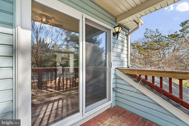 a view of a house with a yard and large tree