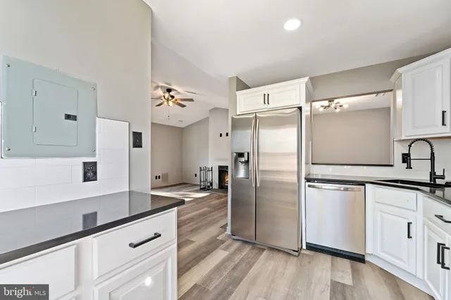 a kitchen with stainless steel appliances a refrigerator sink and microwave