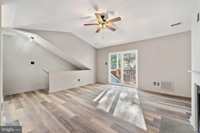 a view of a livingroom with a ceiling fan and window