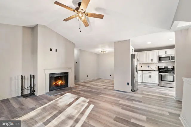 a view of a kitchen with a sink and a fireplace