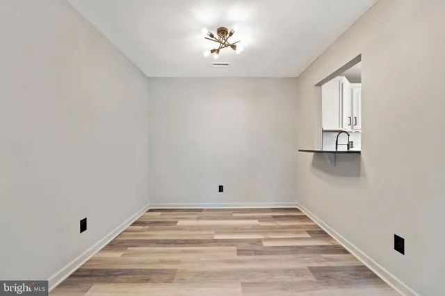 a room with a hardwood and ceiling fan