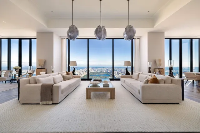 a living room with furniture ceiling fan and a large window