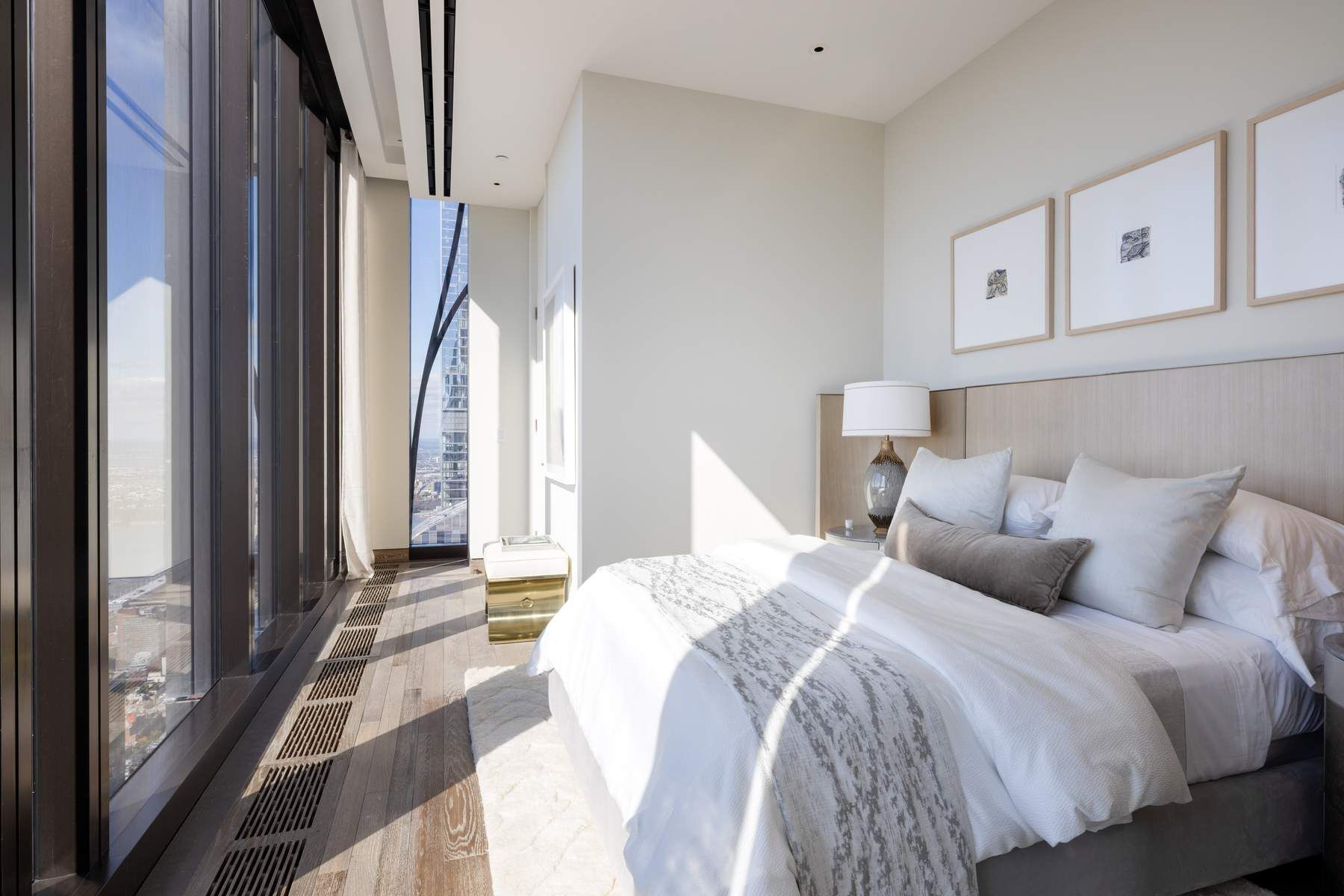 111 West 57th Street, Unit PH76 Manhattan, NY 10019 - Photo 16 of 40 a bedroom with a bed and a large window