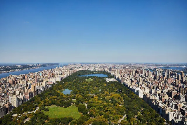 a living room with furniture and large windows