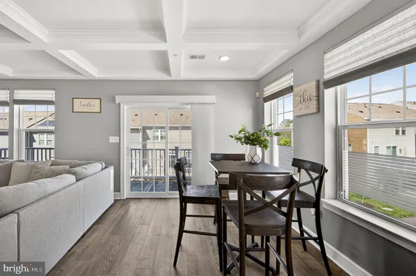 a large white kitchen with lots of counter space a sink and stainless steel appliances