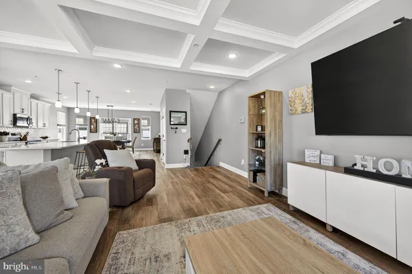 a large kitchen with stainless steel appliances lots of counter space and wooden floor